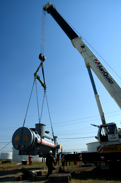 A 115,000 pound heat exchanger is lifted off a flatbed truck at Delaware City Refinery.