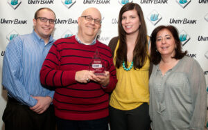 One of our Silver ASTRA Awards was for documentary video services, in the "Video Up to 3 Minutes" category, for a series of business banking customer videos produced for Unity Bank, Clinton, NJ. Posing with the award at the bank's headquarters are (from left): Dustin Coughlin, Marketing Coordinator, Unity Bank; LMC managing partner Steve Lubetkin; Crystal Stoneback Rose, Assistant Vice President, Marketing, Unity Bank, and Rosemary Fellner, Vice President, Marketing, Unity Bank.