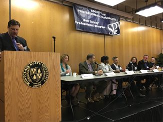Ken HUnter, APR, at lectern, moderates 2017 PRSA-NJ Meet the Media panel, at Montclair State University, March 30.